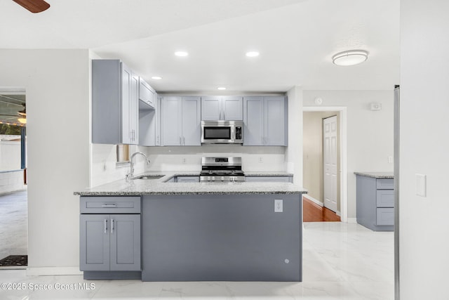 3845 Spring Creek Ln, Titusville, FL 32780 - kitchen featuring stainless steel appliances, gray cabinetry, light marble finish floors, a ceiling fan, and recessed lighting