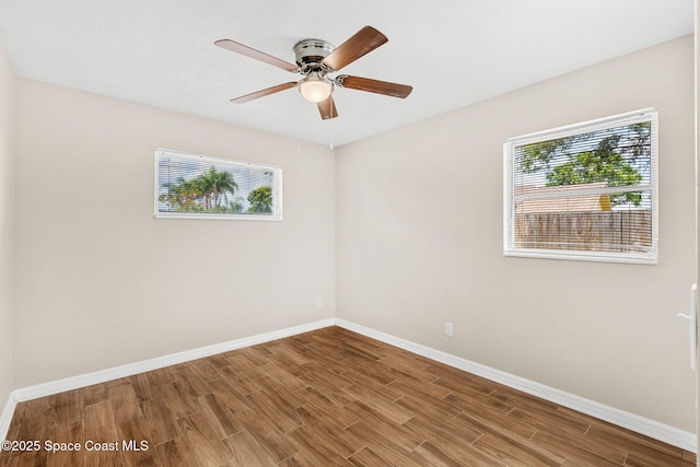 3845 Spring Creek Ln, Titusville, FL 32780 - empty room featuring healthy amount of natural light, wood finished floors, and a ceiling fan