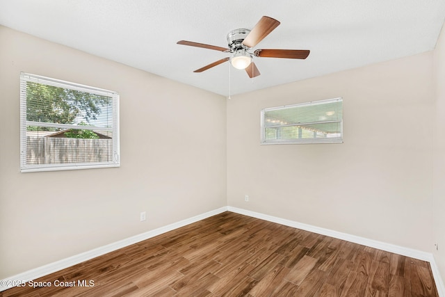 3845 Spring Creek Ln, Titusville, FL 32780 - unfurnished room with wood finished floors, plenty of natural light, and a ceiling fan