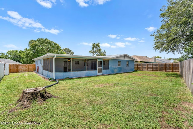 3845 Spring Creek Ln, Titusville, FL 32780 - back of property with a sunroom, a fenced backyard, and a ceiling fan