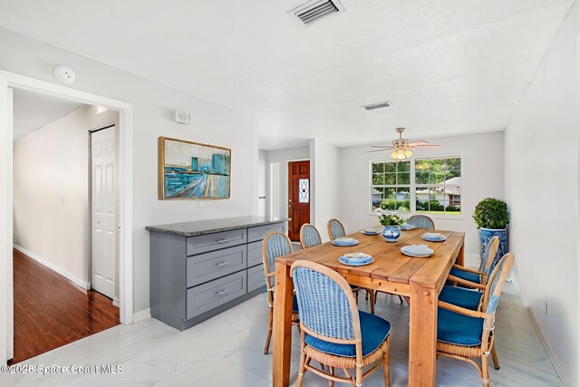 3845 Spring Creek Ln, Titusville, FL 32780 - dining space with ceiling fan and light marble finish flooring
