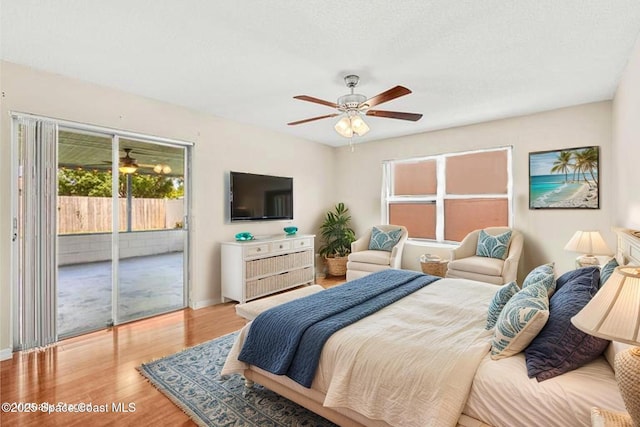 3845 Spring Creek Ln, Titusville, FL 32780 - bedroom with access to exterior, wood finished floors, and ceiling fan