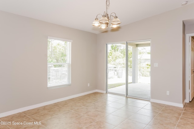1610 Yahner St SE, Palm Bay, FL 32909 - spare room with a chandelier, light tile patterned floors, baseboards, vaulted ceiling, and a smoke detector