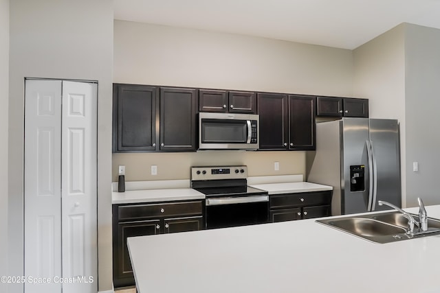 1610 Yahner St SE, Palm Bay, FL 32909 - kitchen featuring appliances with stainless steel finishes, a sink, and light countertops
