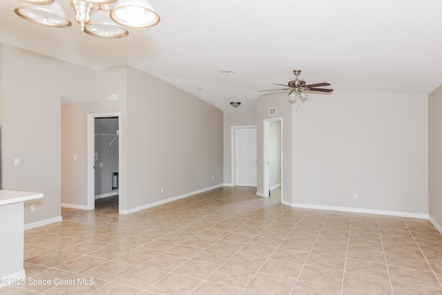 1610 Yahner St SE, Palm Bay, FL 32909 - empty room with a ceiling fan, light tile patterned floors, lofted ceiling, and baseboards