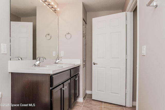 1610 Yahner St SE, Palm Bay, FL 32909 - bathroom with tile patterned floors, double vanity, and baseboards
