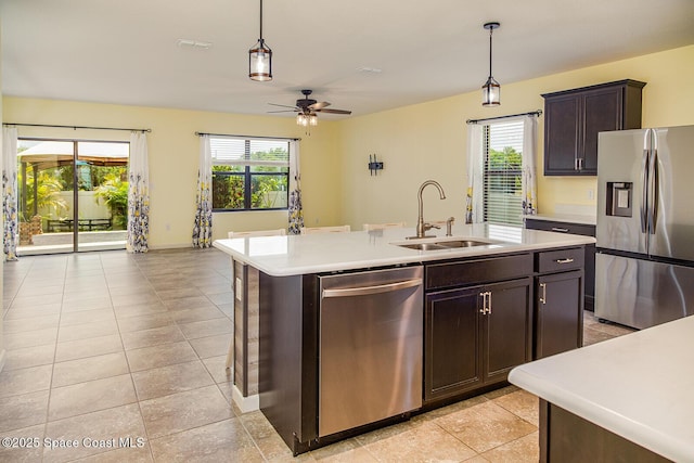 3847 Loggerhead Ln, Mims, FL 32754 - kitchen with stainless steel appliances, a sink, light countertops, and pendant lighting