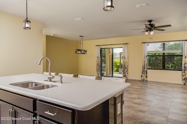 3847 Loggerhead Ln, Mims, FL 32754 - kitchen featuring a sink, light countertops, pendant lighting, a ceiling fan, and a kitchen island with sink