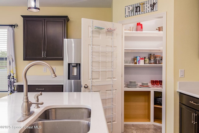 3847 Loggerhead Ln, Mims, FL 32754 - kitchen with a sink, dark brown cabinets, light countertops, stainless steel fridge with ice dispenser, and tile patterned floors
