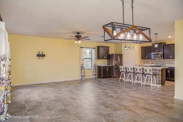 3847 Loggerhead Ln, Mims, FL 32754 - kitchen featuring stainless steel appliances, light countertops, and dark brown cabinets