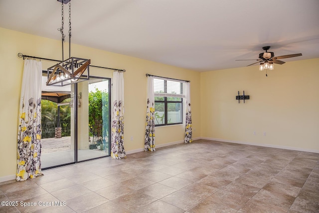 3847 Loggerhead Ln, Mims, FL 32754 - empty room with a chandelier, baseboards, and a ceiling fan