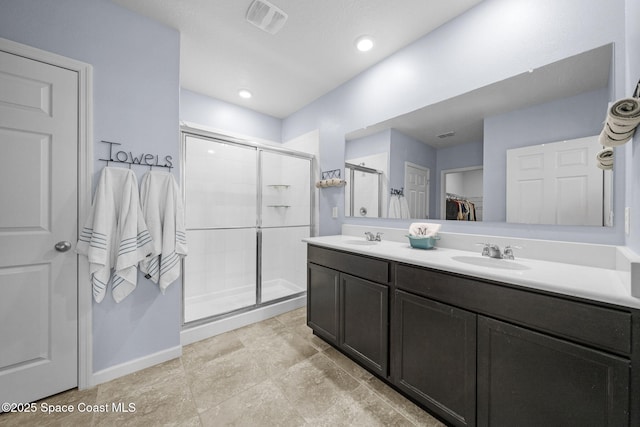 3847 Loggerhead Ln, Mims, FL 32754 - bathroom featuring a shower stall, a spacious closet, baseboards, and double vanity