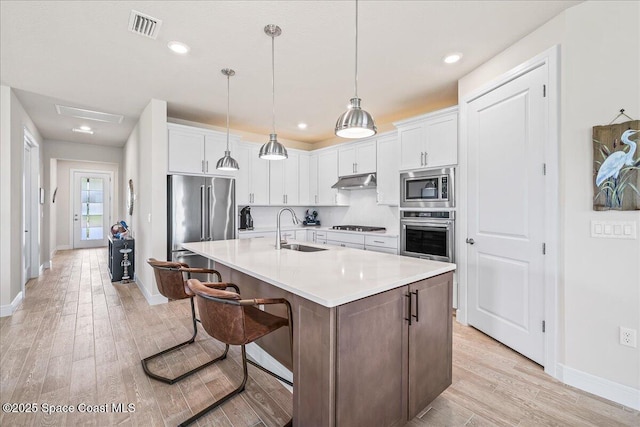 2902 Tidepool Pl, Melbourne, FL 32940 - kitchen with stainless steel appliances, a sink, baseboards, light wood-type flooring, and recessed lighting