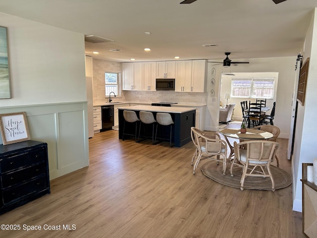 dining space with a ceiling fan, light wood-type flooring, and recessed lighting