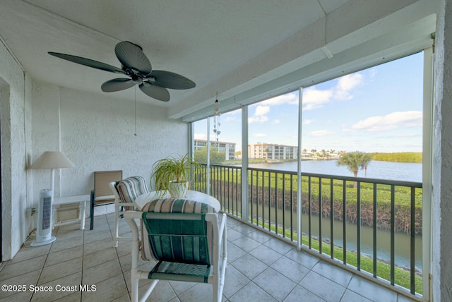 sunroom / solarium with a water view