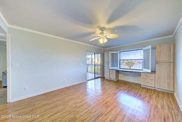 unfurnished bedroom with light wood-type flooring, ornamental molding, baseboards, and ceiling fan