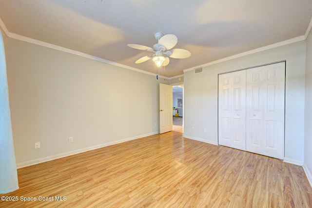 unfurnished bedroom with light wood finished floors, baseboards, ornamental molding, a closet, and ceiling fan