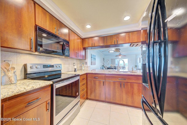kitchen with black appliances, a sink, decorative backsplash, brown cabinets, and ornamental molding