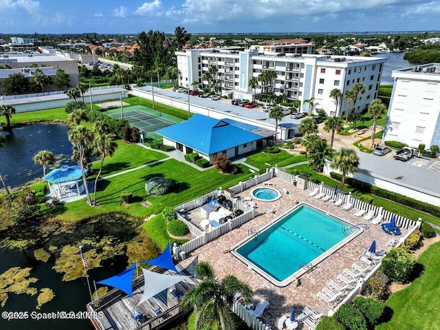 drone / aerial view of a pool and a large body of water