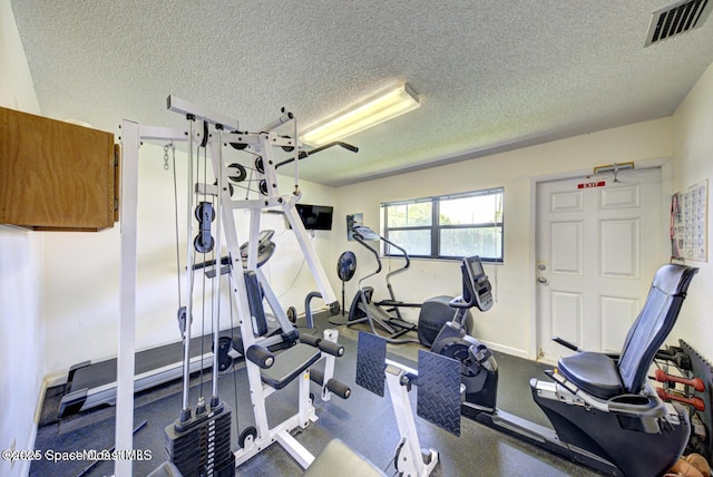 exercise area with a textured ceiling