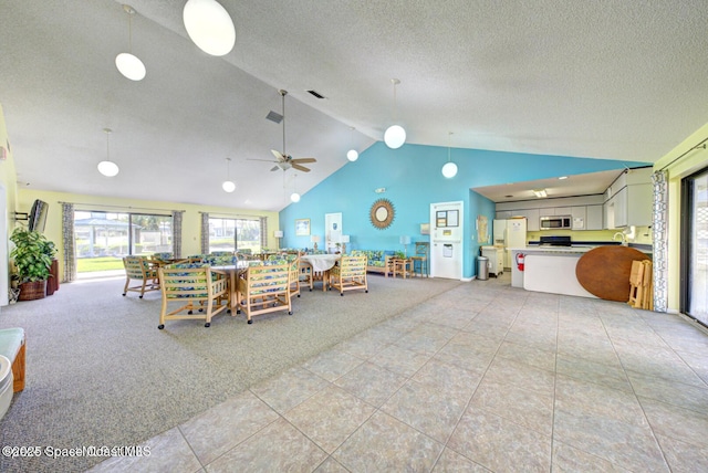 living room featuring a textured ceiling, light colored carpet, light tile patterned floors, a ceiling fan, and high vaulted ceiling