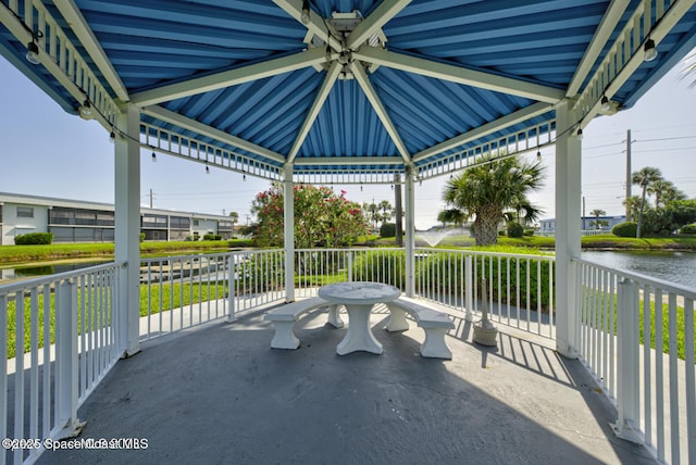 view of patio featuring a gazebo and a water view