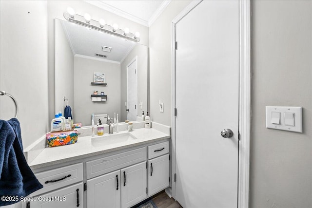 bathroom with ornamental molding and vanity