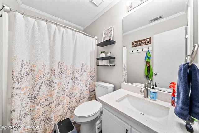 bathroom featuring toilet, crown molding, vanity, and a textured ceiling