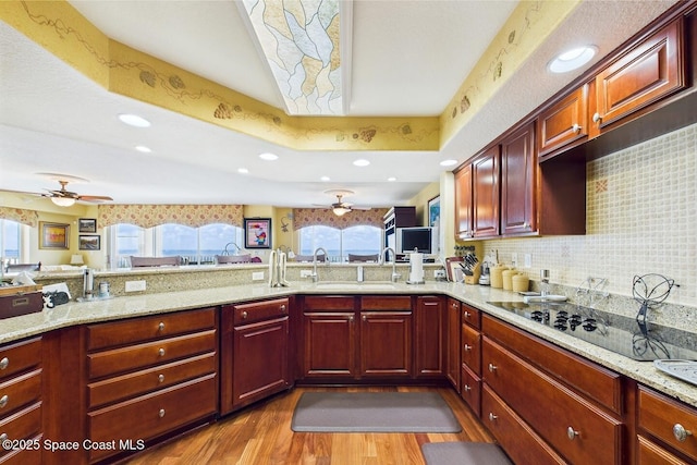 732 Bayside Dr Unit 501, Cape Canaveral, FL 32920 - kitchen featuring ceiling fan, wood finished floors, a sink, light stone counters, and recessed lighting