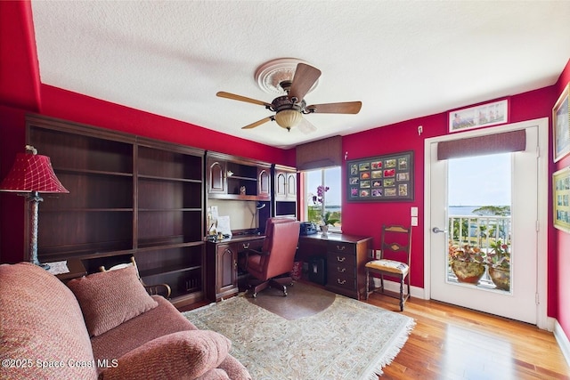 732 Bayside Dr Unit 501, Cape Canaveral, FL 32920 - office featuring a ceiling fan, light wood-style flooring, baseboards, and a textured ceiling