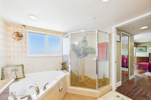 732 Bayside Dr Unit 501, Cape Canaveral, FL 32920 - full bath featuring a garden tub, a stall shower, a textured ceiling, and wallpapered walls