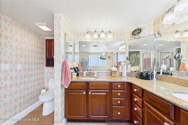 732 Bayside Dr Unit 501, Cape Canaveral, FL 32920 - full bath with wallpapered walls, a stall shower, double vanity, a textured ceiling, and toilet