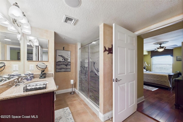 732 Bayside Dr Unit 501, Cape Canaveral, FL 32920 - bathroom with ensuite bathroom, a stall shower, tile patterned flooring, baseboards, and a textured ceiling