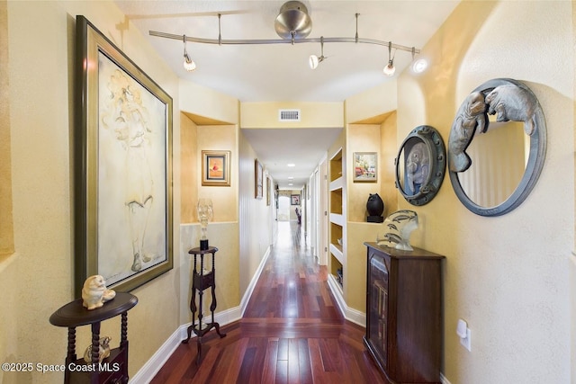 732 Bayside Dr Unit 501, Cape Canaveral, FL 32920 - corridor featuring hardwood / wood-style floors, baseboards, and rail lighting