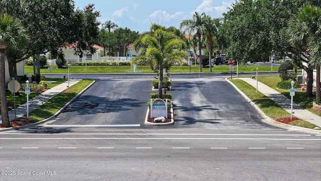 732 Bayside Dr Unit 501, Cape Canaveral, FL 32920 - view of asphalt road featuring traffic signs, curbs, and sidewalks