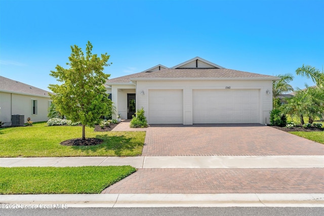 1342 Great Belt Cir, Melbourne, FL 32940 - ranch-style house with decorative driveway, an attached garage, a front yard, and central AC