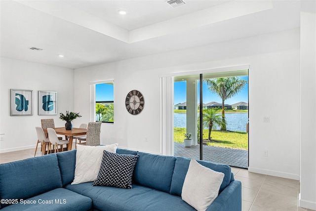 1342 Great Belt Cir, Melbourne, FL 32940 - living room with a water view, light tile patterned floors, baseboards, and recessed lighting