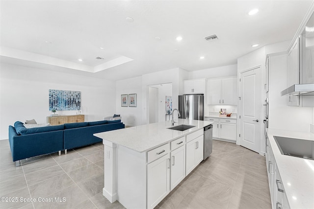 1342 Great Belt Cir, Melbourne, FL 32940 - kitchen featuring appliances with stainless steel finishes, a sink, a center island with sink, white cabinets, and open floor plan