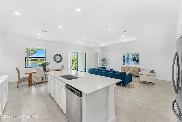 1342 Great Belt Cir, Melbourne, FL 32940 - kitchen featuring a sink, appliances with stainless steel finishes, white cabinets, a center island with sink, and baseboards