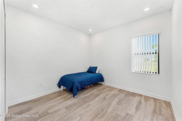 1342 Great Belt Cir, Melbourne, FL 32940 - unfurnished bedroom featuring wood finished floors, baseboards, and recessed lighting