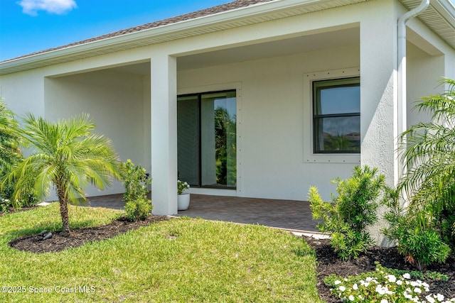 1342 Great Belt Cir, Melbourne, FL 32940 - doorway to property featuring stucco siding and a lawn