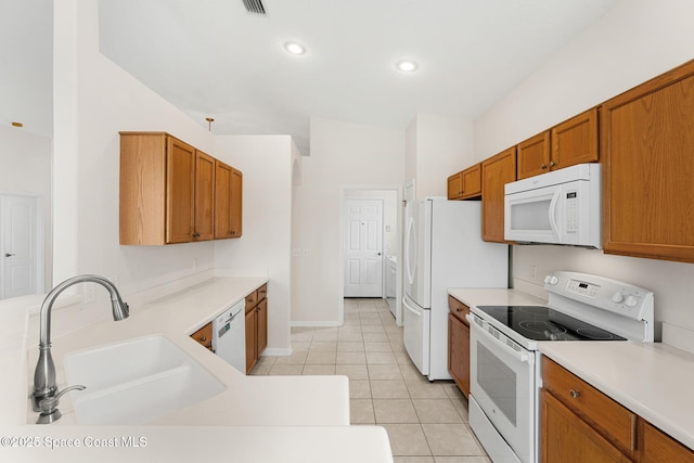 4882 Worthington Cir, Rockledge, FL 32955 - kitchen with white appliances, a sink, brown cabinets, light countertops, and recessed lighting