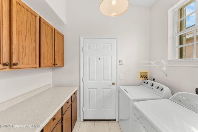 4882 Worthington Cir, Rockledge, FL 32955 - laundry area featuring washing machine and dryer, cabinet space, and light tile patterned floors