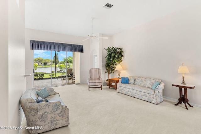 4882 Worthington Cir, Rockledge, FL 32955 - living room featuring carpet floors, a water view, and baseboards