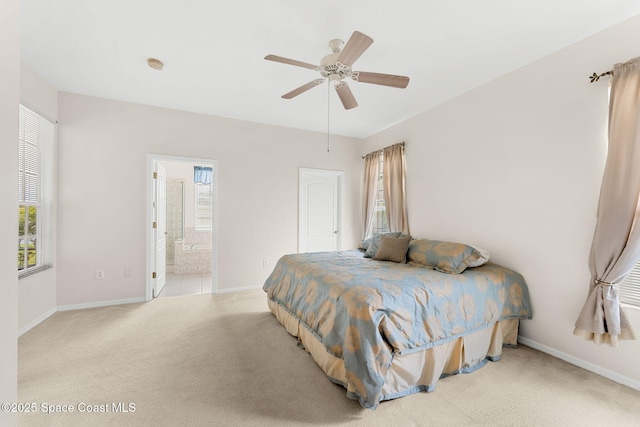 4882 Worthington Cir, Rockledge, FL 32955 - carpeted bedroom with baseboards, ensuite bathroom, and ceiling fan