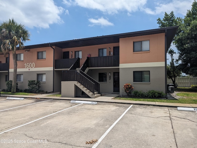 1600 University Ln Unit 1504, Cocoa, FL 32922 - view of property featuring uncovered parking and stairway