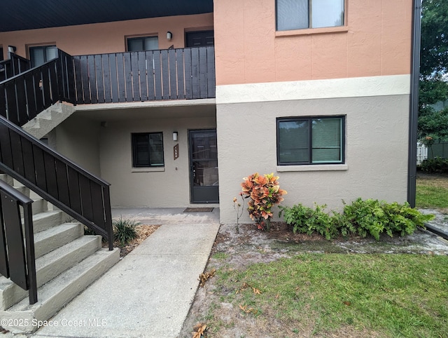 1600 University Ln Unit 1504, Cocoa, FL 32922 - doorway to property featuring stucco siding and a balcony