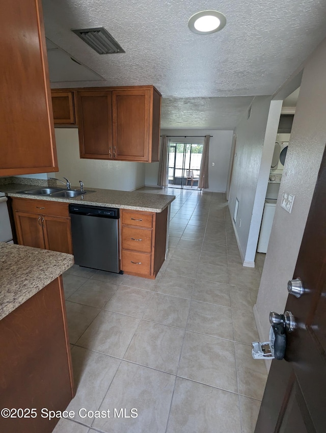 1600 University Ln Unit 1504, Cocoa, FL 32922 - kitchen with dishwasher, a sink, brown cabinets, a textured ceiling, and light tile patterned flooring
