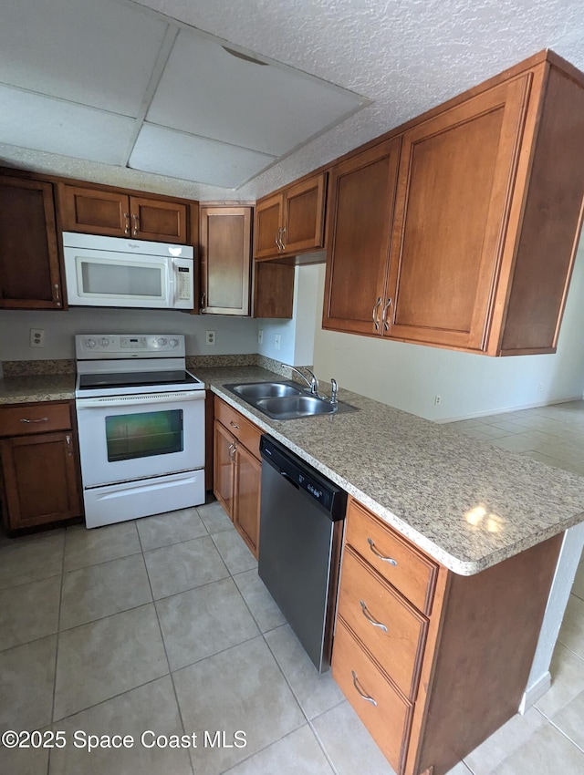 1600 University Ln Unit 1504, Cocoa, FL 32922 - kitchen with white appliances, a sink, light tile patterned flooring, and brown cabinets