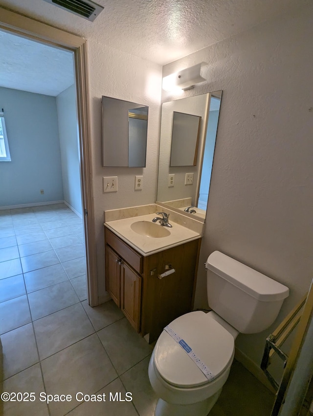 1600 University Ln Unit 1504, Cocoa, FL 32922 - half bath with toilet, vanity, a textured wall, tile patterned floors, and a textured ceiling